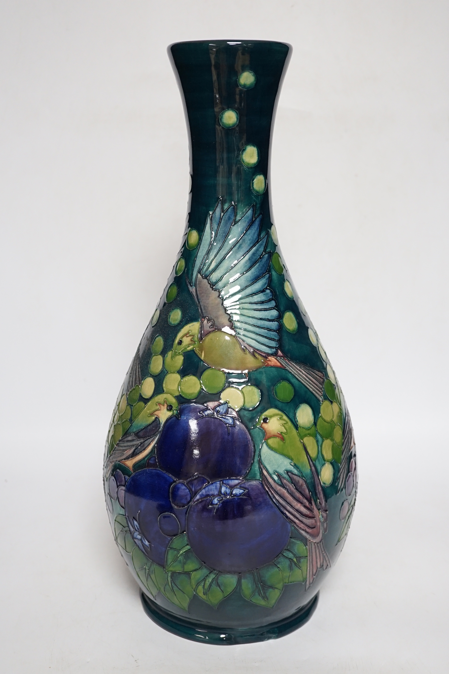 A large boxed Moorcroft vase, ‘Finches pattern’, on a dark blue-green ground, bell date mark to base, signed LS and dated 27.8.92, 42cm high